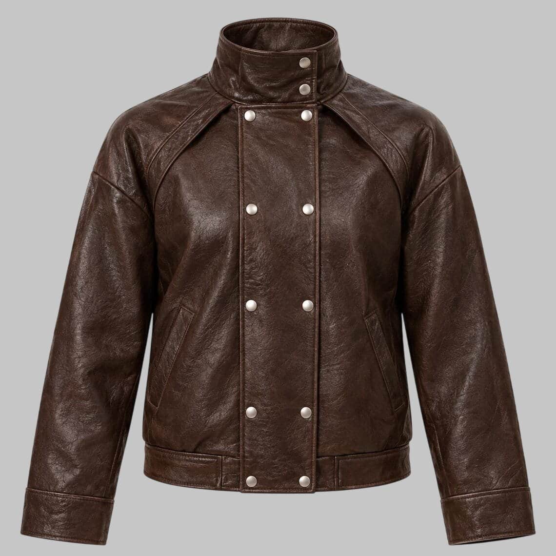 A dark brown leather jacket with a high stand-up collar, double-breasted snap-button front, and angled shoulders, shown against a solid gray background.