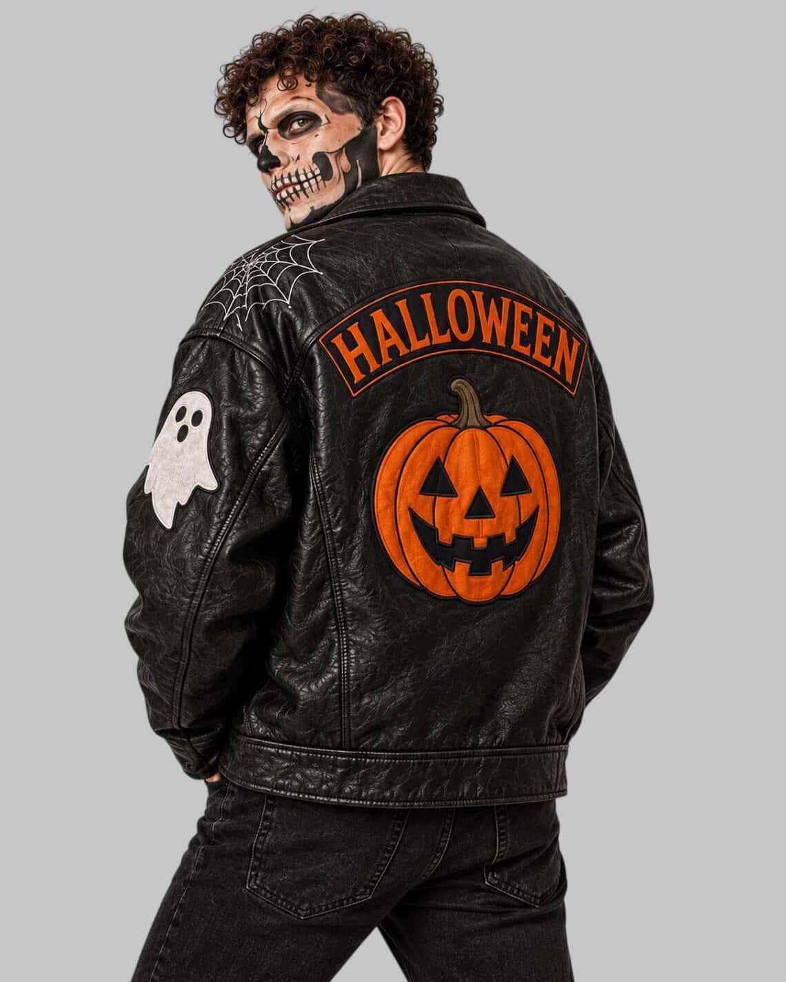A man wearing a black leather jacket with Halloween-themed back graphics, including a large orange jack-o'-lantern and the word 'HALLOWEEN' in orange, shown against a plain gray background.